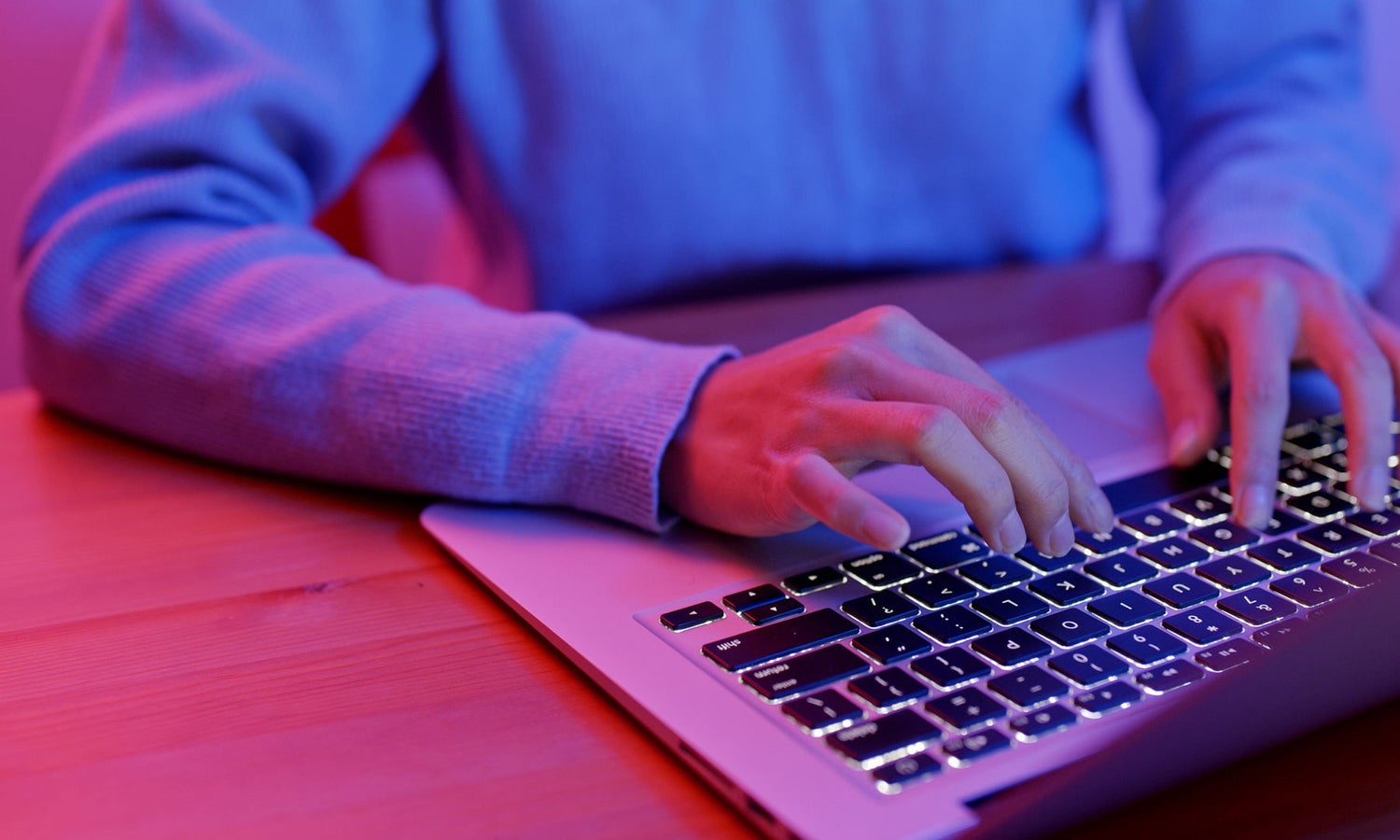 Close up of man's hands typing on laptop keyboard
